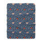 A navy blue Sherpa fleece blanket with a floral pattern inspired by William Morris's design.