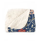 A navy blue Sherpa fleece blanket with a floral pattern inspired by William Morris's design.