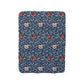 A navy blue Sherpa fleece blanket with a floral pattern inspired by William Morris's design.