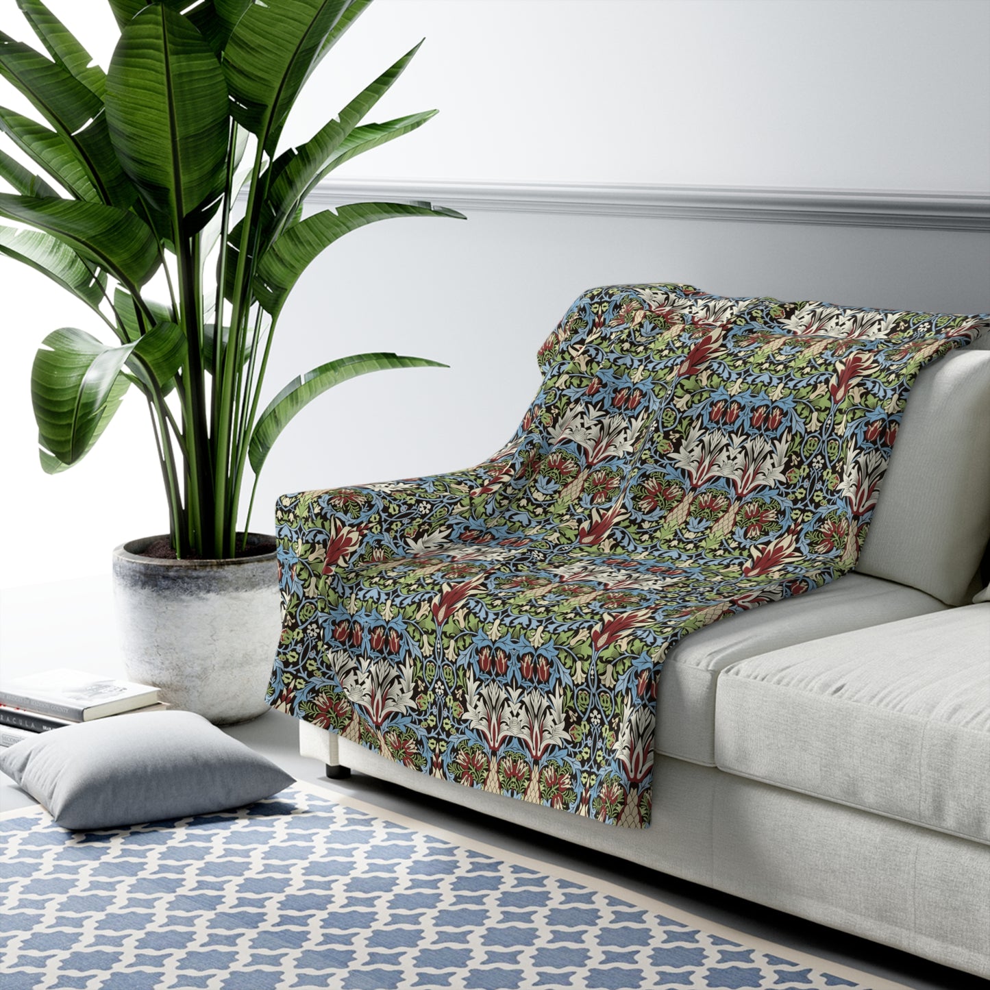 Floral-patterned chaise lounge on a white sofa with a plant and rug in the background from William Morris