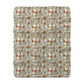 A Sherpa fleece blanket with a floral pattern in beige, green, blue, and red colors on a white background.