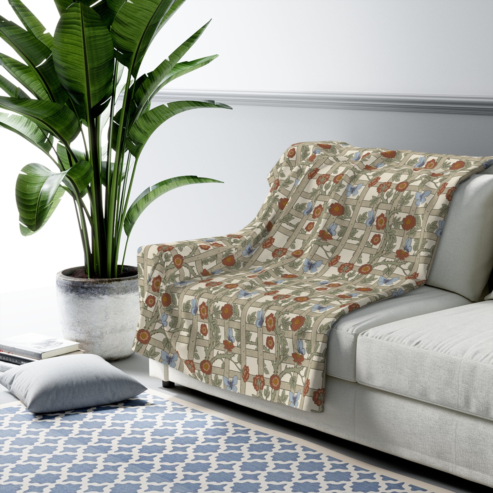 A Sherpa fleece blanket with a floral pattern in beige, green, blue, and red colours on a white background.