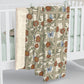 A Sherpa fleece blanket with a floral pattern in beige, green, blue, and red colours on a white background.