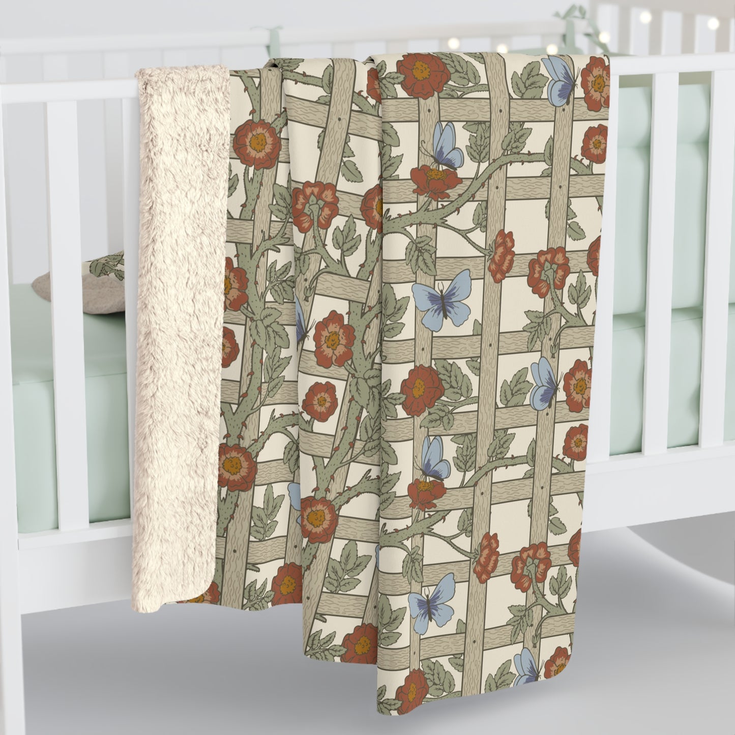 A Sherpa fleece blanket with a floral pattern in beige, green, blue, and red colours on a white background.