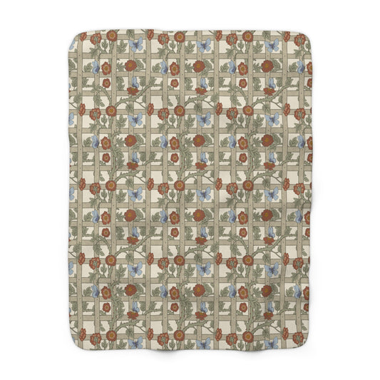 A Sherpa fleece blanket with a floral pattern in beige, green, blue, and red colours on a white background.