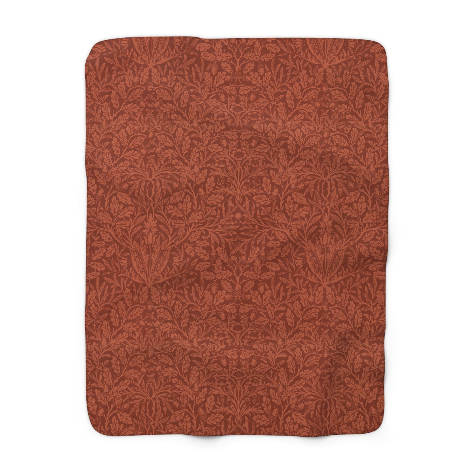 A rectangular Sherpa fleece blanket with a rust-coloured floral pattern inspired by William Morris & Co - Acorns and Oak Trees Collection.
