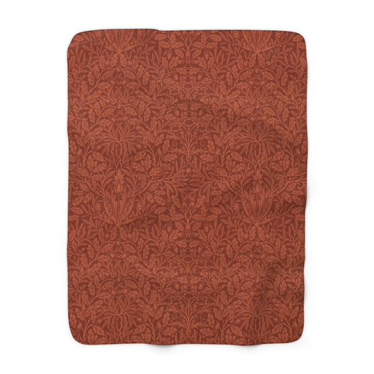 A rectangular Sherpa fleece blanket with a rust-coloured floral pattern inspired by William Morris & Co - Acorns and Oak Trees Collection.