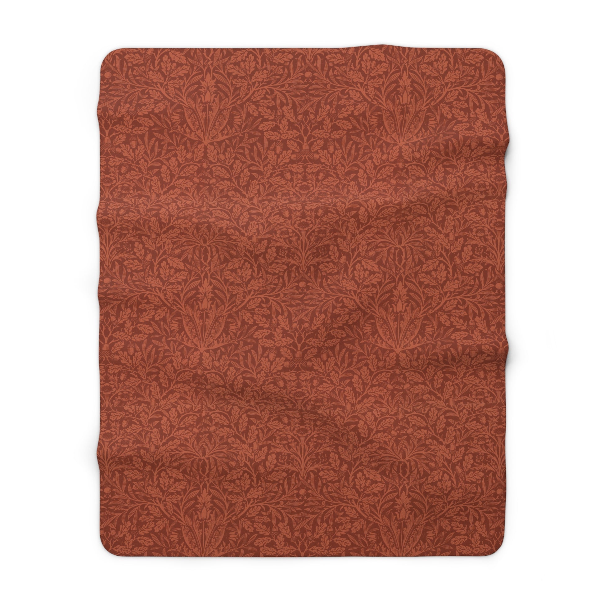 A rectangular Sherpa fleece blanket with a rust-coloured floral pattern inspired by William Morris & Co - Acorns and Oak Trees Collection.