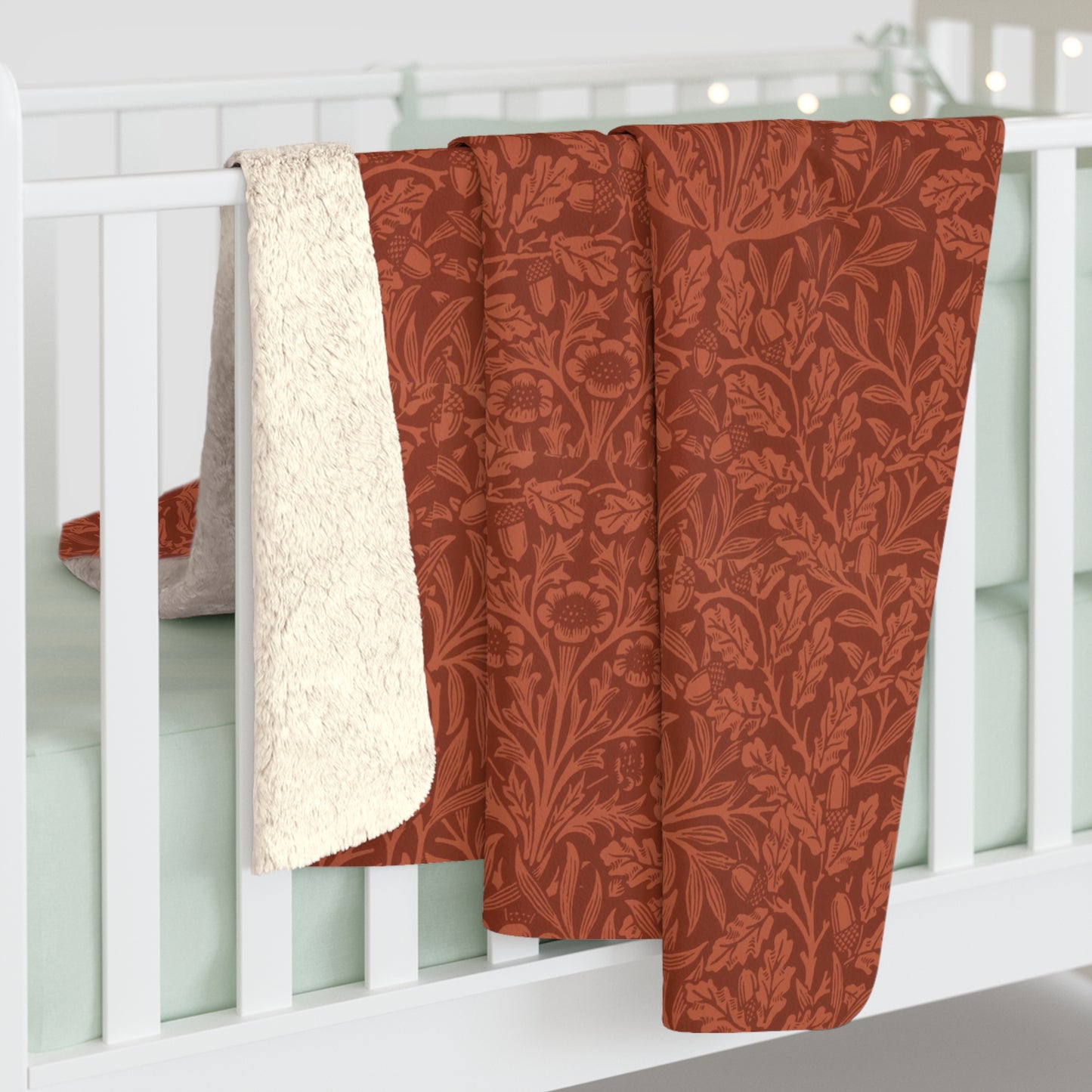 A rectangular Sherpa fleece blanket with a rust-coloured floral pattern inspired by William Morris & Co - Acorns and Oak Trees Collection.