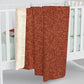 A rectangular Sherpa fleece blanket with a rust-coloured floral pattern inspired by William Morris & Co - Acorns and Oak Trees Collection.