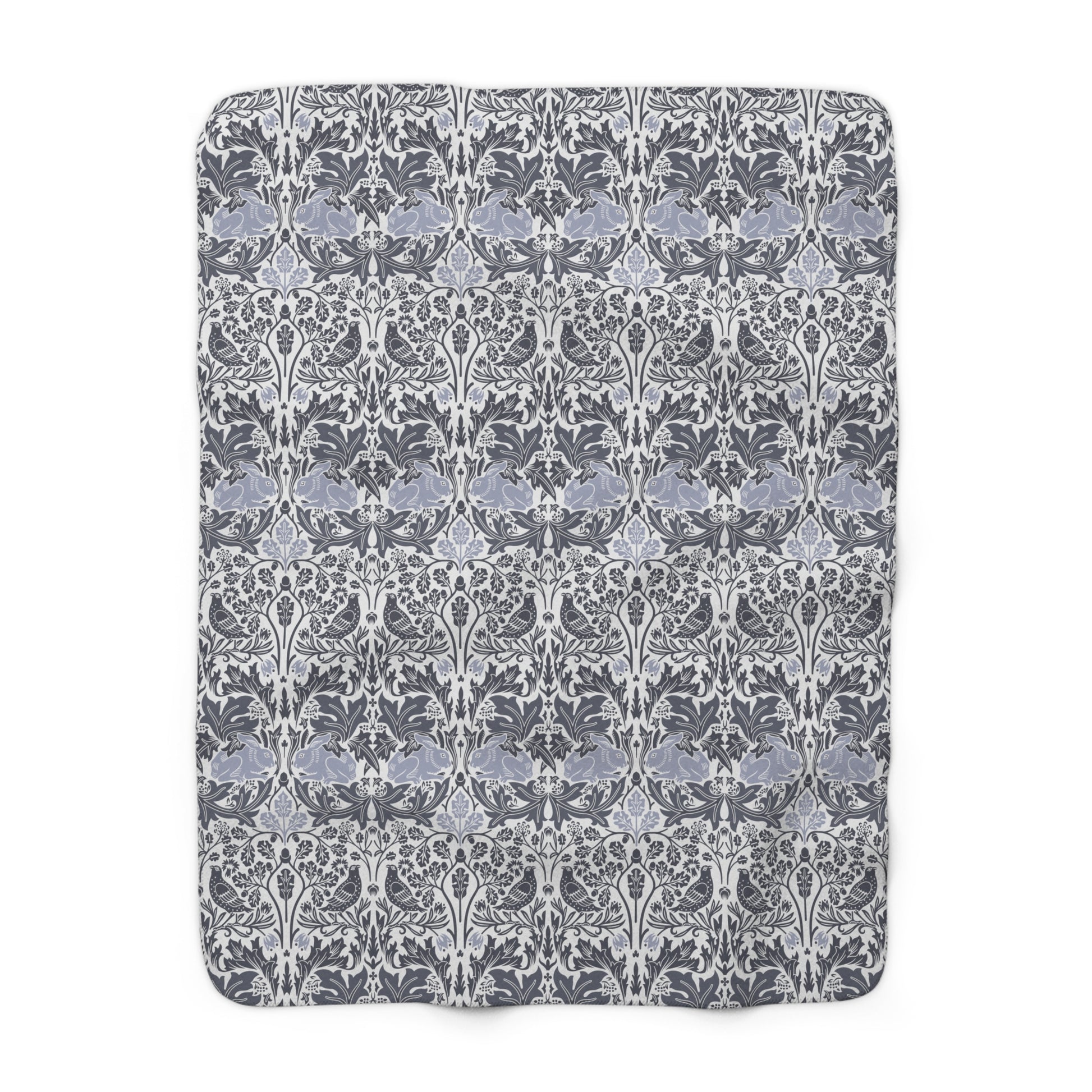 A grey Sherpa fleece blanket with a floral pattern, inspired by William Morris, from the Brer Rabbit collection.