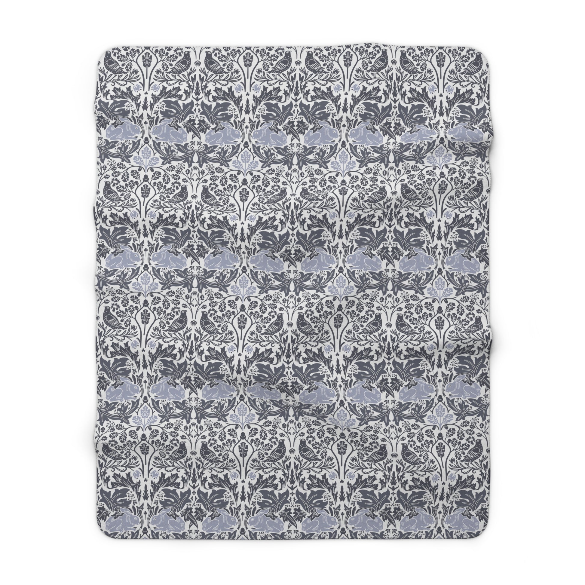 A grey Sherpa fleece blanket with a floral pattern, inspired by William Morris, from the Brer Rabbit collection.