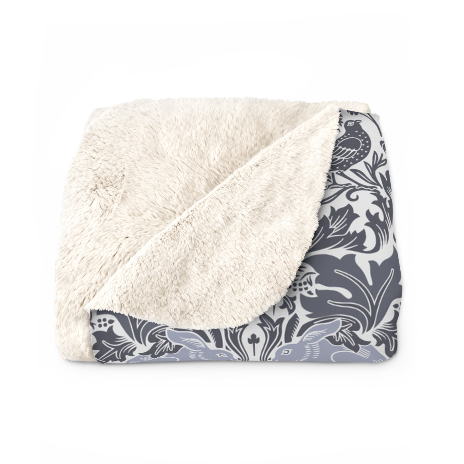 A grey Sherpa fleece blanket with a floral pattern, inspired by William Morris, from the Brer Rabbit collection.
