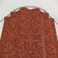 Red floral patterned shower curtain on a silver rod against a white background