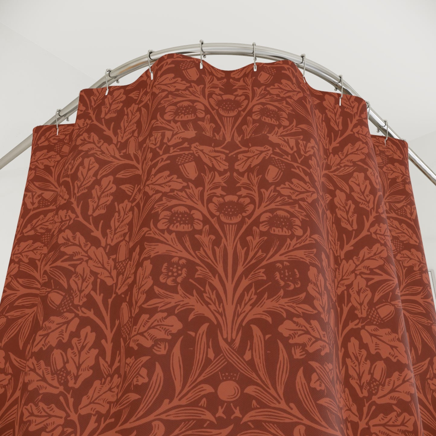 Red floral patterned shower curtain on a silver rod against a white background