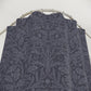 Dark floral patterned fabric on a metal rod against a white background