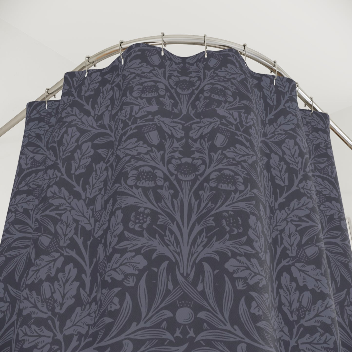 Dark floral patterned fabric on a metal rod against a white background