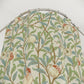Fabric with nature-themed design featuring birds and pomegranates on a circular rod.