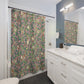 Bathroom with a floral shower curtain, white vanity, and mirror.
