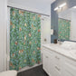 Bathroom with a floral shower curtain, sink, and mirror.