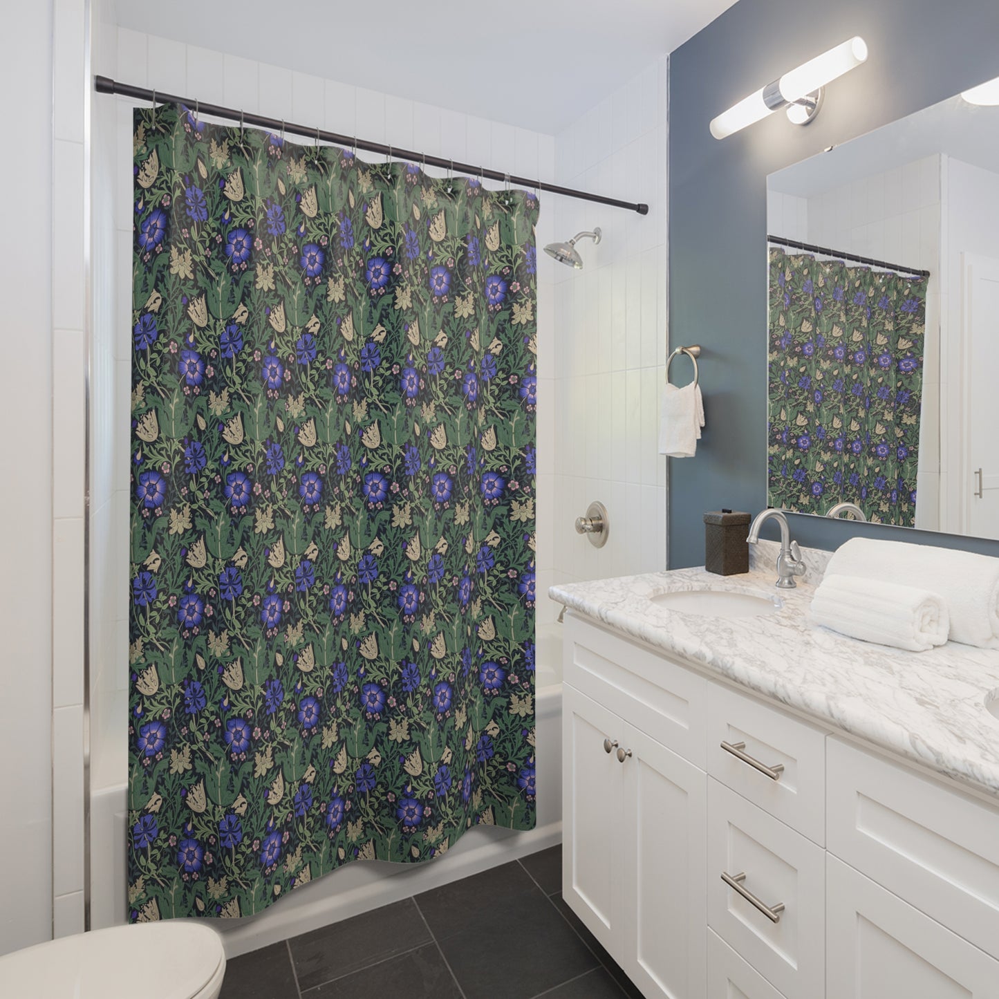 Bathroom with floral shower curtain, white vanity, and mirror.