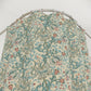 Floral patterned fabric on a metal rod against a white background