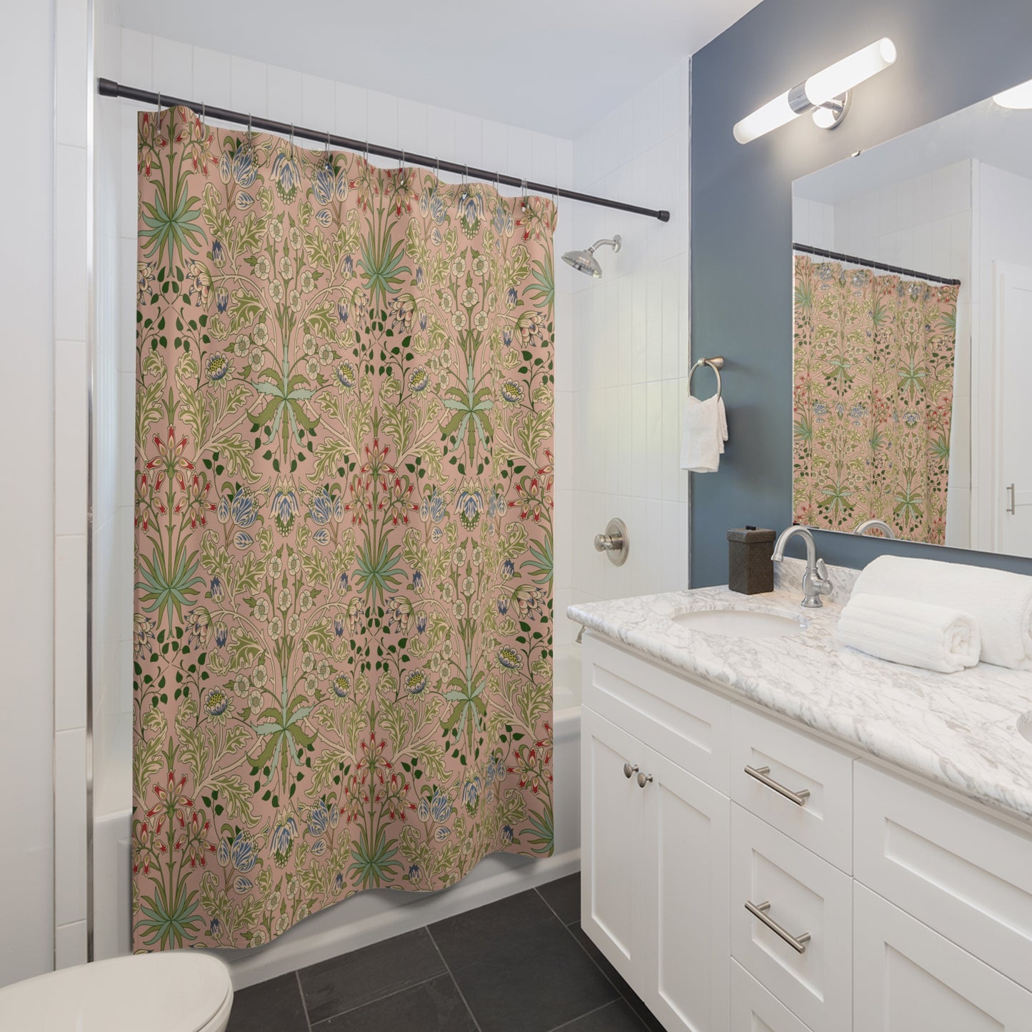 Bathroom with a floral-patterned shower curtain, white vanity, and mirror.