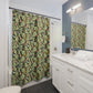 Bathroom with a floral-patterned shower curtain and white vanity.
