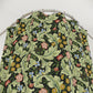 Floral patterned PVC shower curtain on a metal hanger against a white background