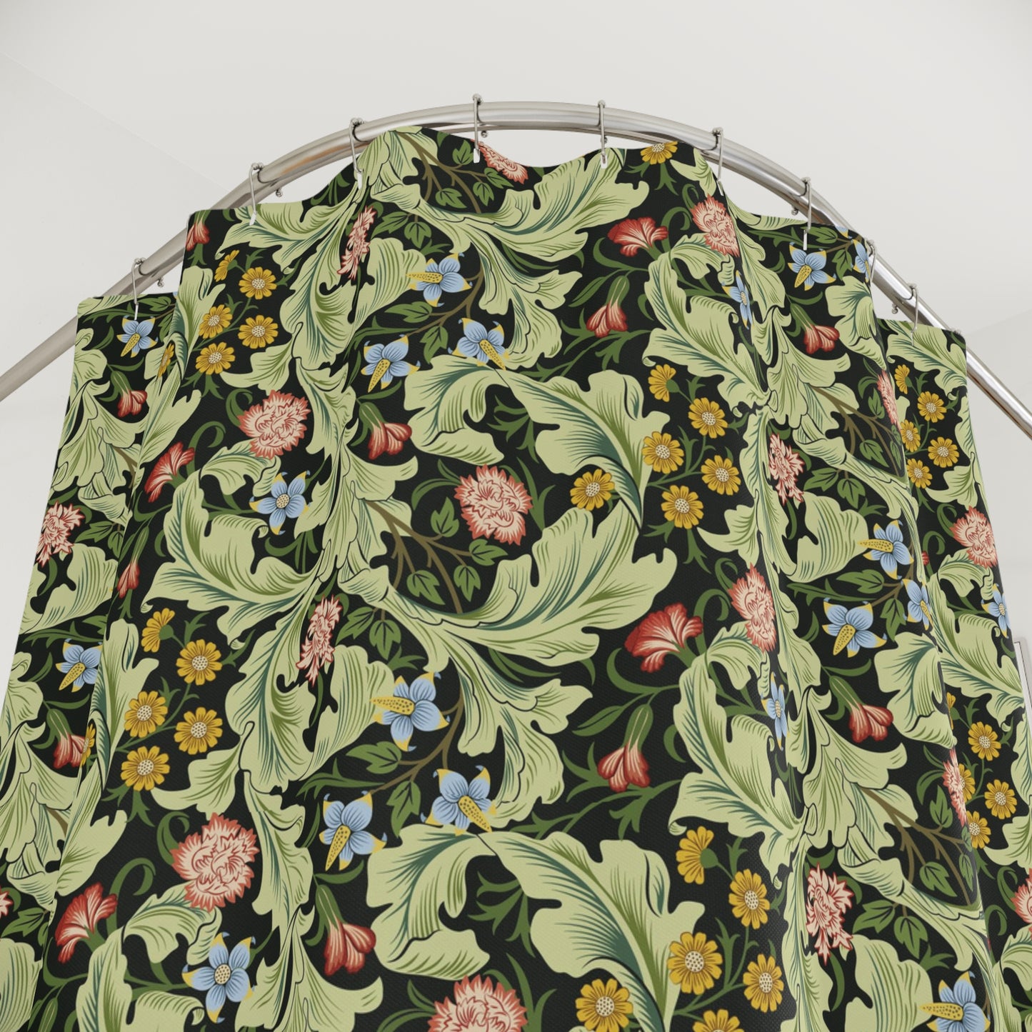 Floral patterned PVC shower curtain on a metal hanger against a white background