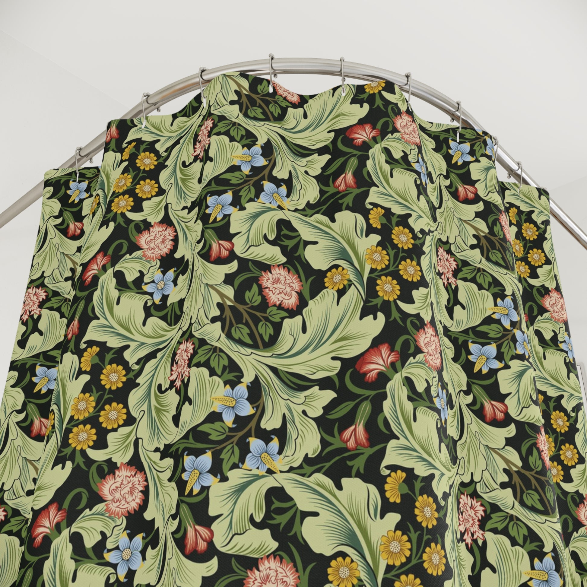 Floral patterned PVC shower curtain on a metal hanger against a white background