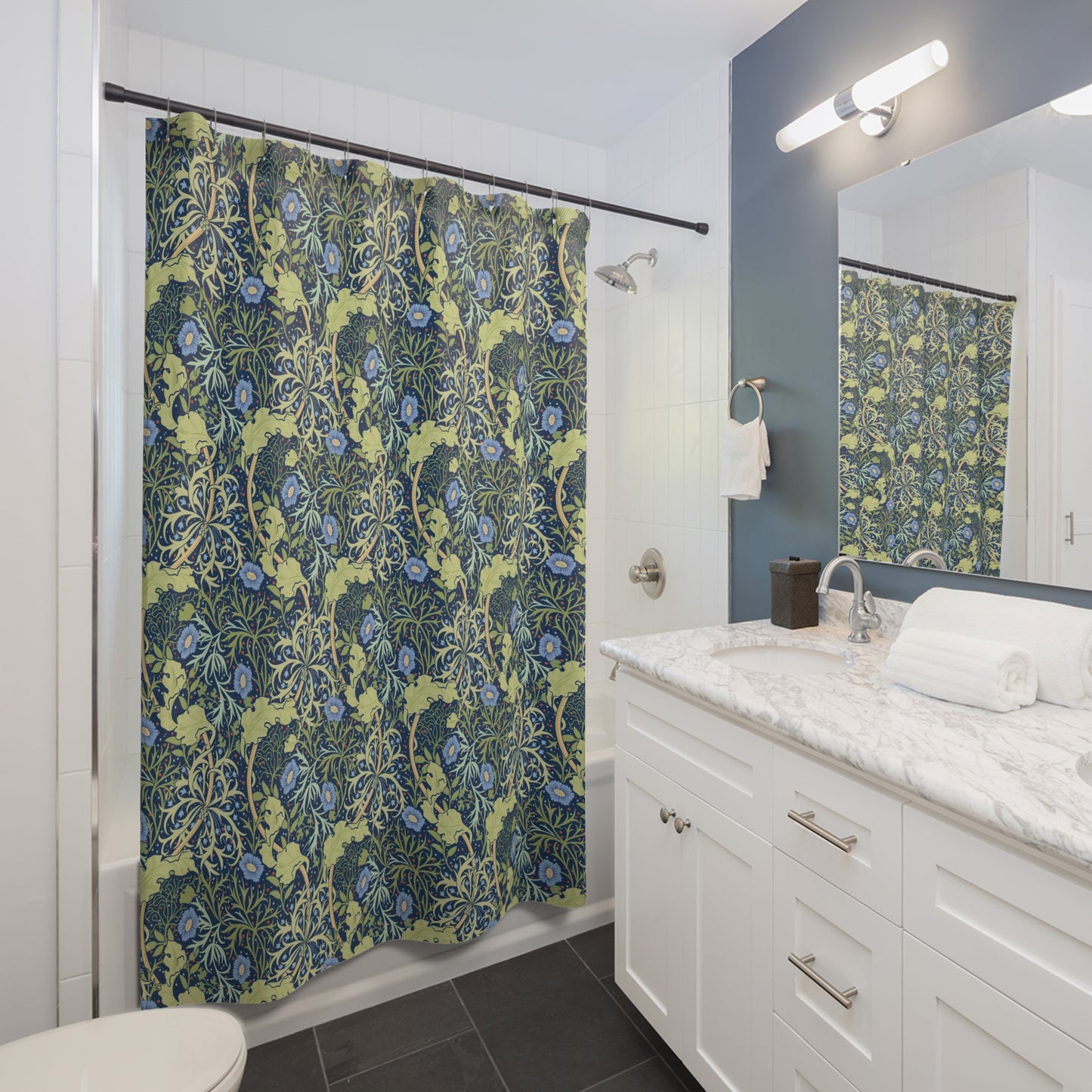 Bathroom with a floral shower curtain, sink, and mirror.