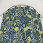 Floral patterned fabric on a metal hanger against a white background