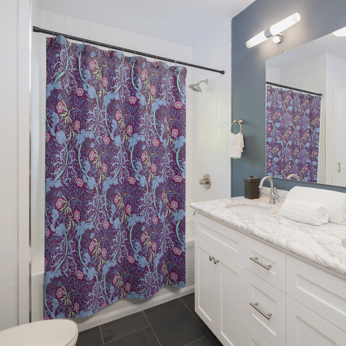 Bathroom with a floral shower curtain, sink, and mirror.