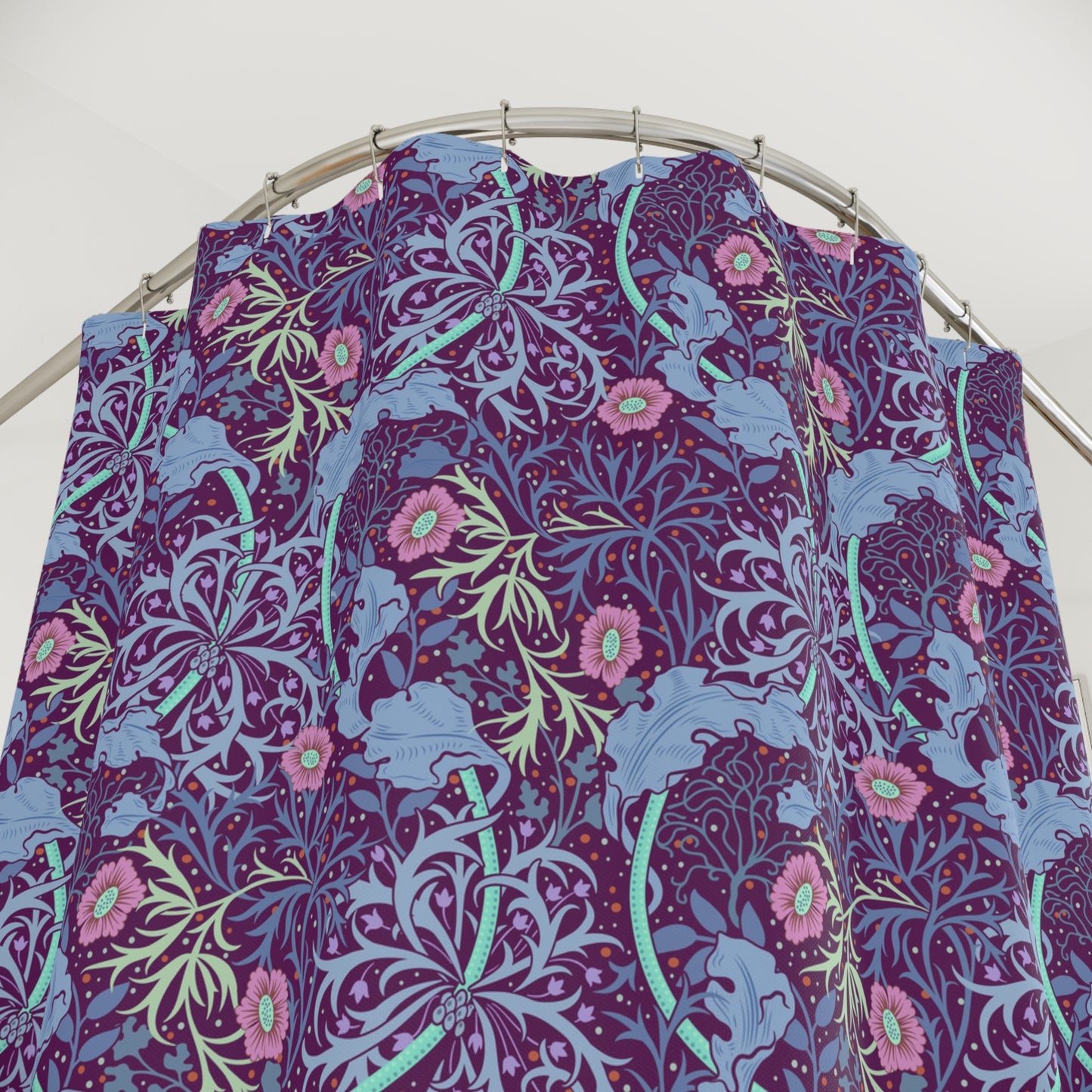 Floral patterned fabric on a metal rod against a white background