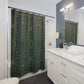 Bathroom with a patterned shower curtain, white vanity, and mirror.