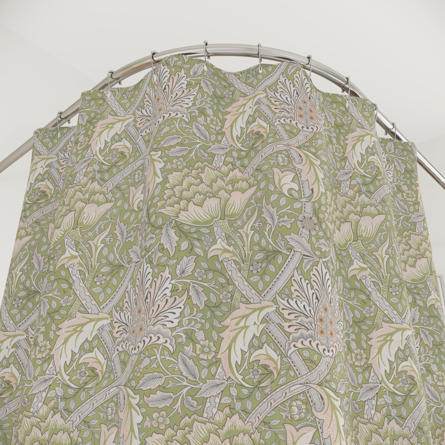 A shower curtain featuring a green floral pattern inspired by William Morris.