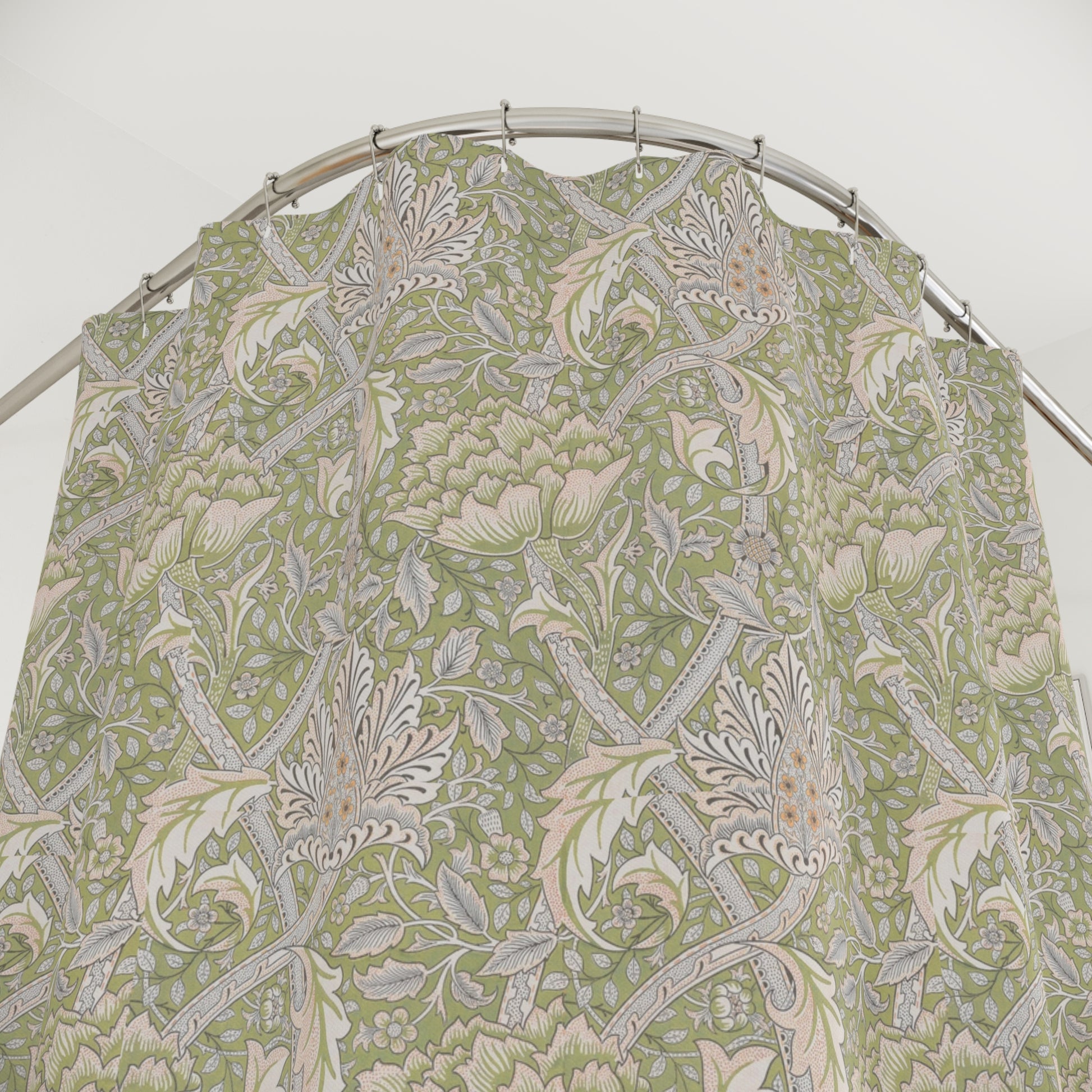 A shower curtain featuring a green floral pattern inspired by William Morris.
