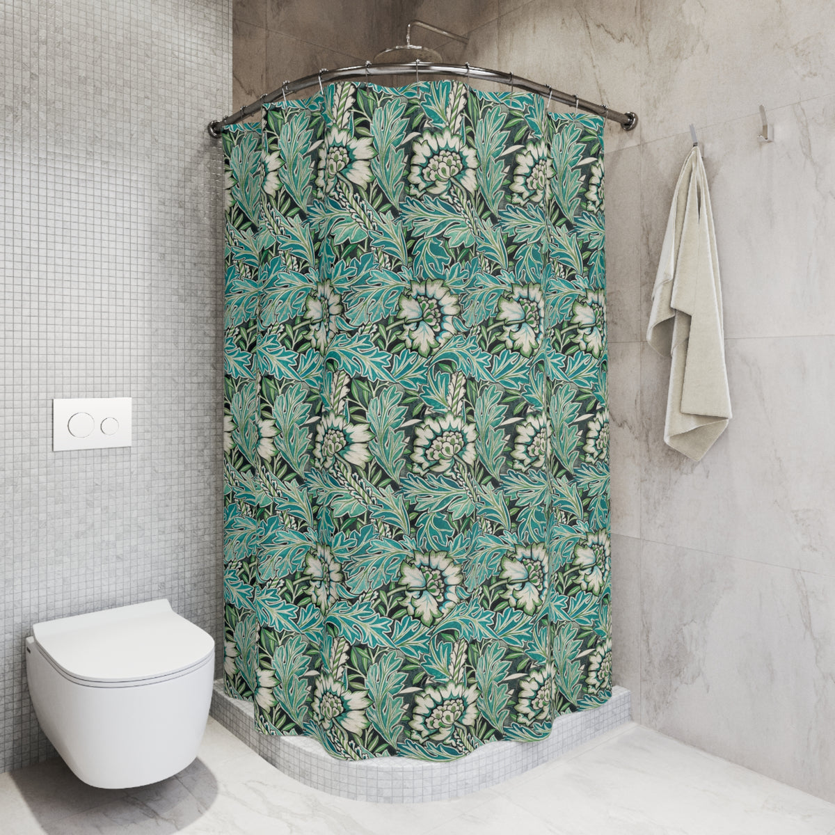 A bathroom scene showing a shower curtain with a teal, green, and white botanical leaf pattern hanging in a shower. The bathroom also features a white vanity with a marble countertop, a mirror, and a blue-gray accent wall.