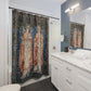 Bathroom with tapestry-style shower curtain featuring angelic figures, white vanity, and mirror.