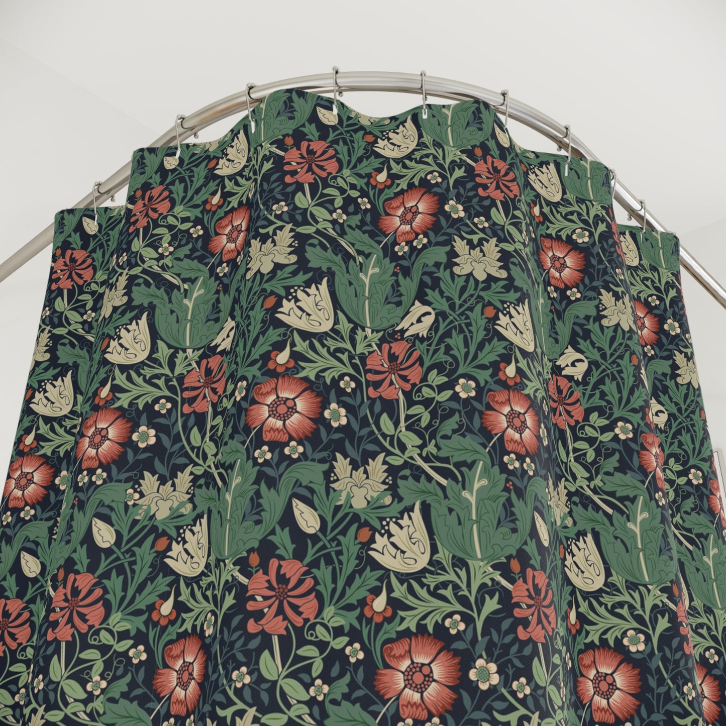 Floral patterned shower fabric on a metal rod against a white background