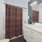 Bathroom with a patterned shower curtain, white vanity, and mirror.