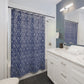 Bathroom with a blue floral shower curtain and white vanity.