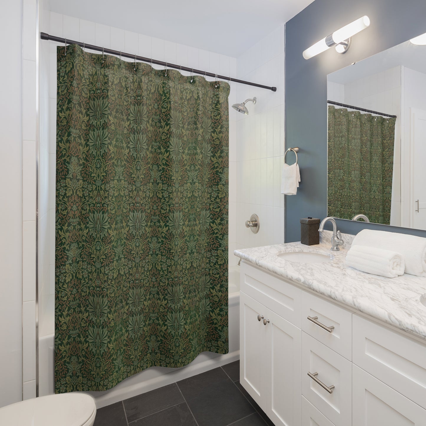 Bathroom with green patterned shower curtain, white vanity, and mirror.