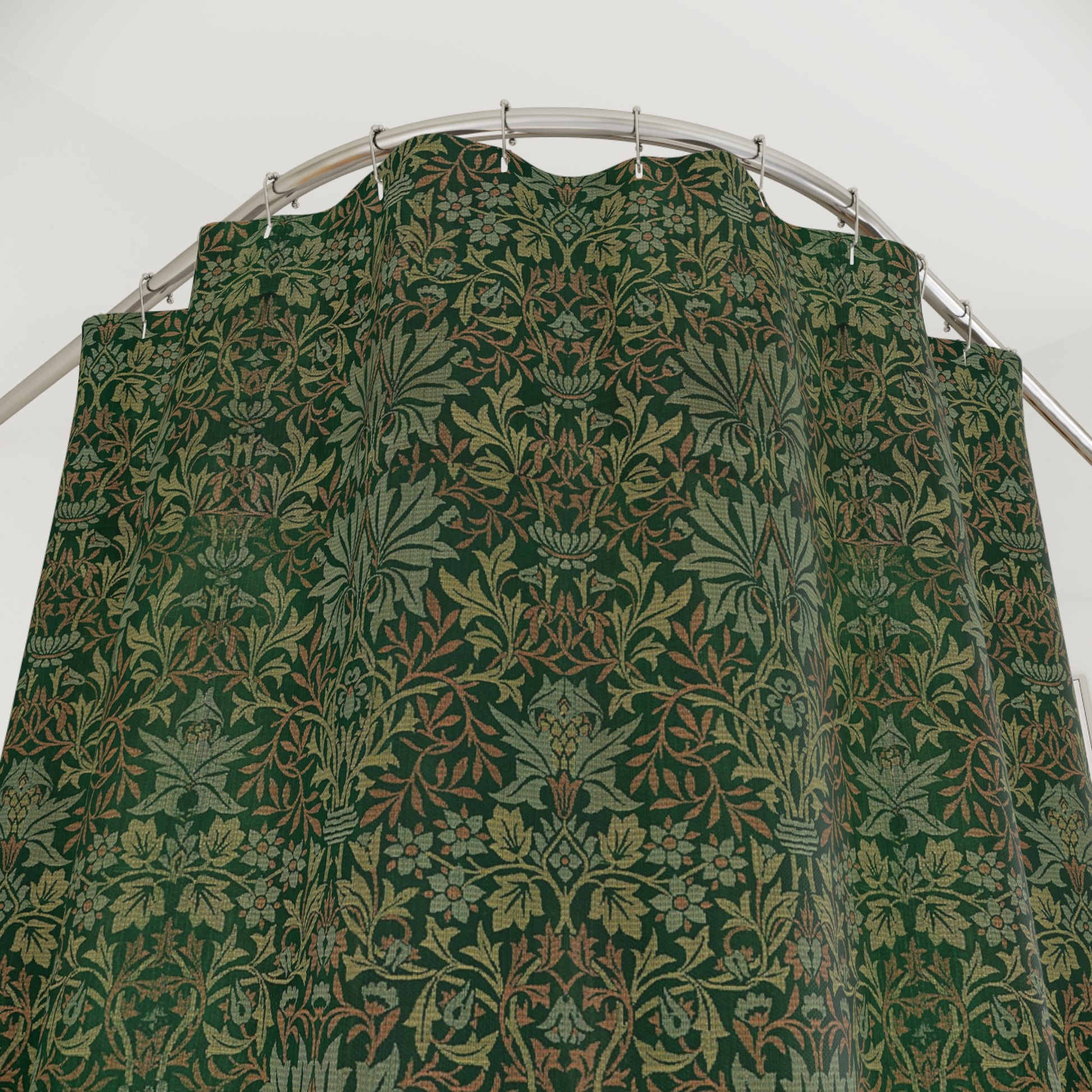 Green patterned fabric on a hanger against a white background