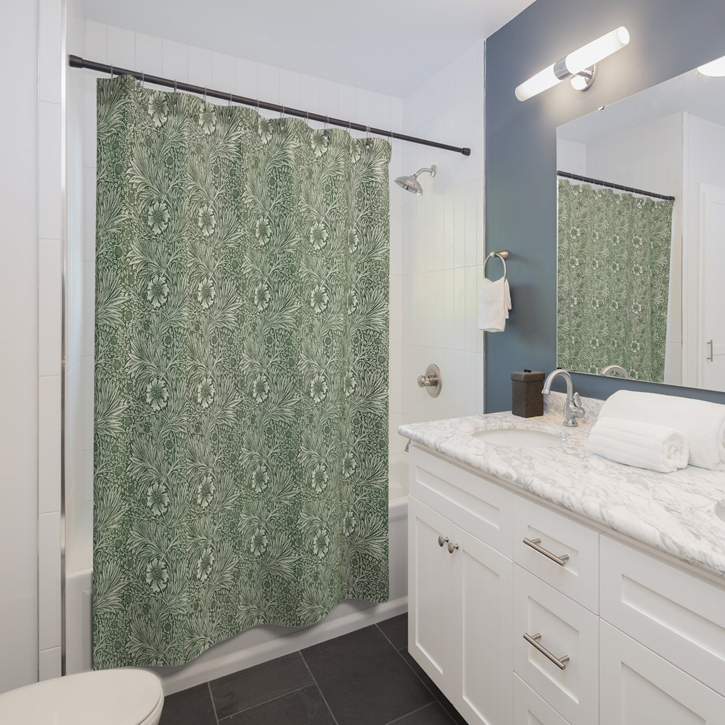 Bathroom with green patterned shower curtain, white vanity, and mirror.