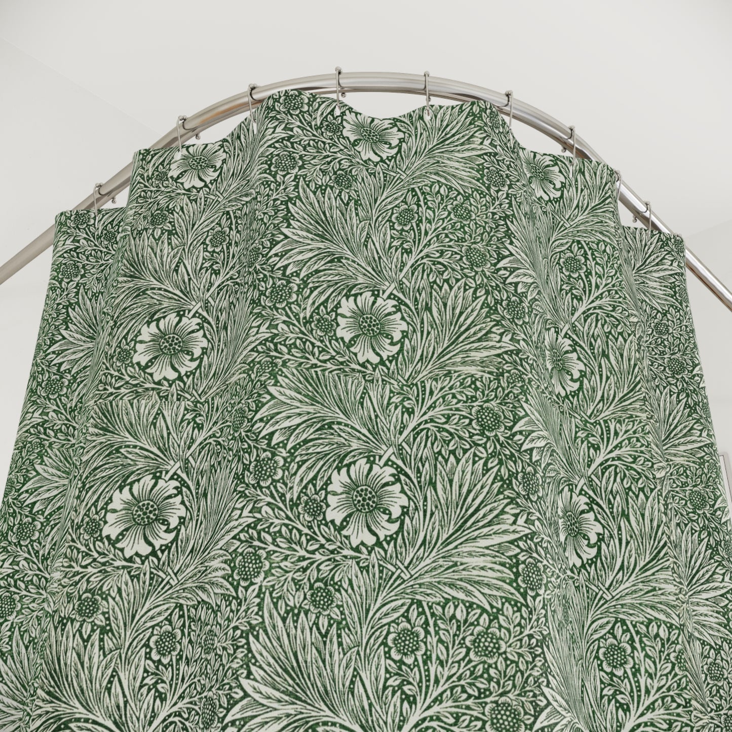 Green floral patterned fabric on a hanger against a white background