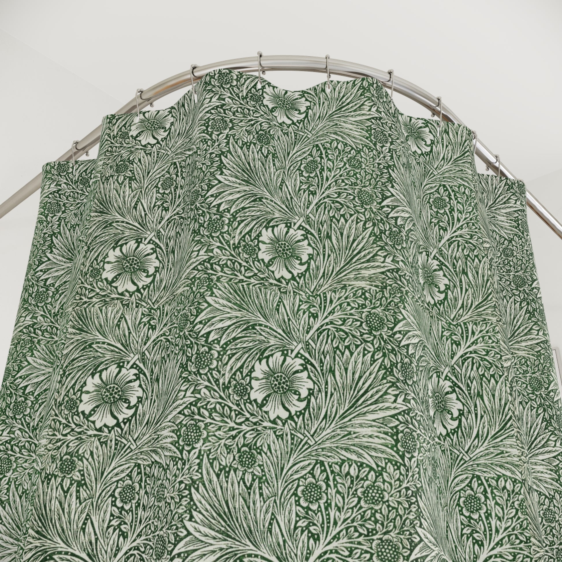 Green floral patterned fabric on a hanger against a white background