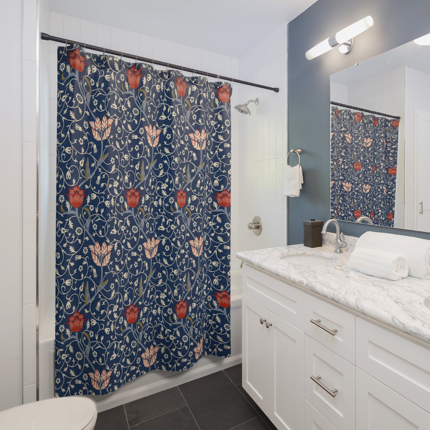 Bathroom with a floral-patterned shower curtain, white vanity, and mirror.