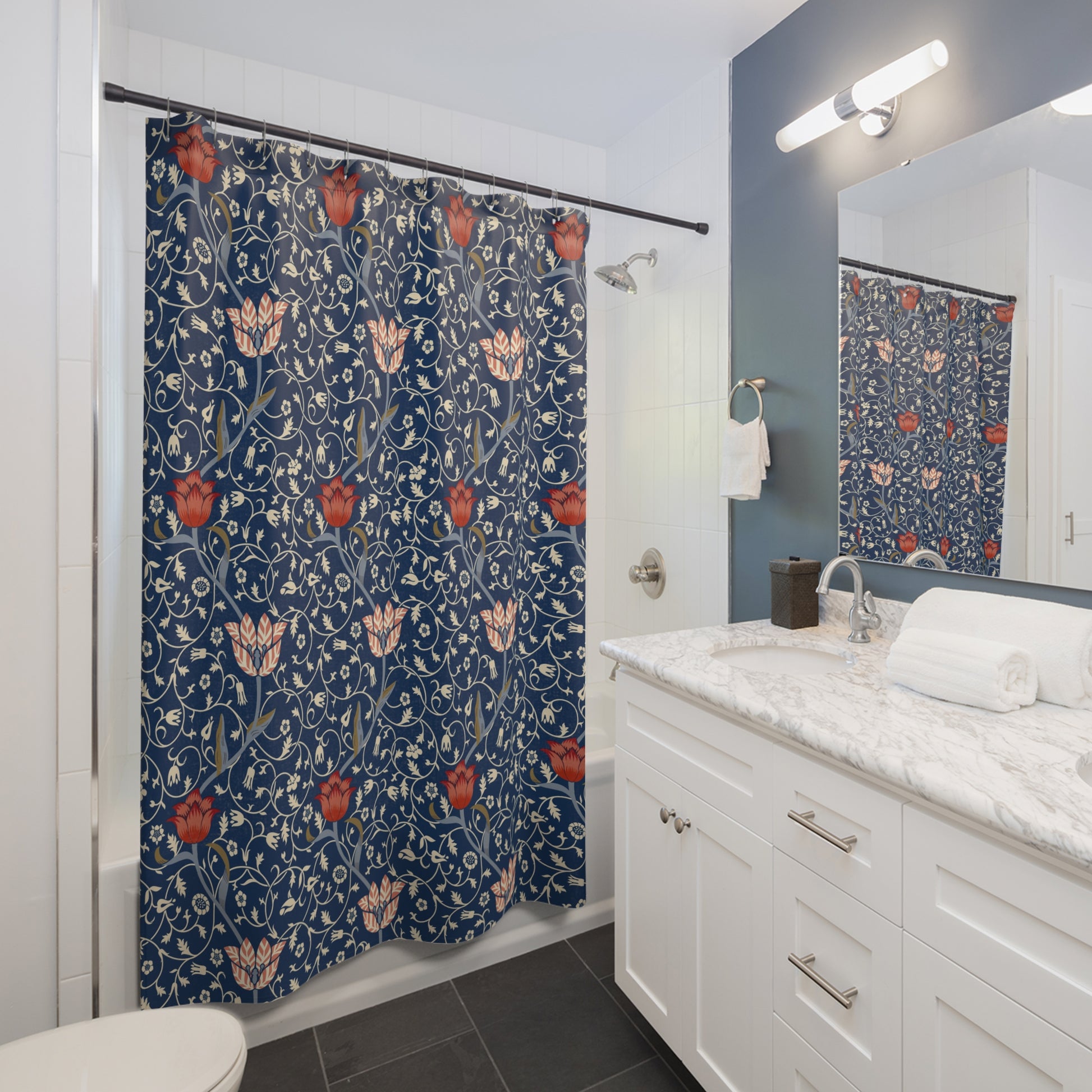Bathroom with a floral-patterned shower curtain, white vanity, and mirror.